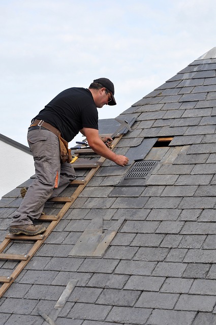 image of man working on roof