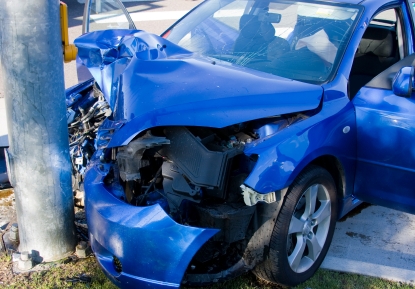 Wrecked car that hit a light pole